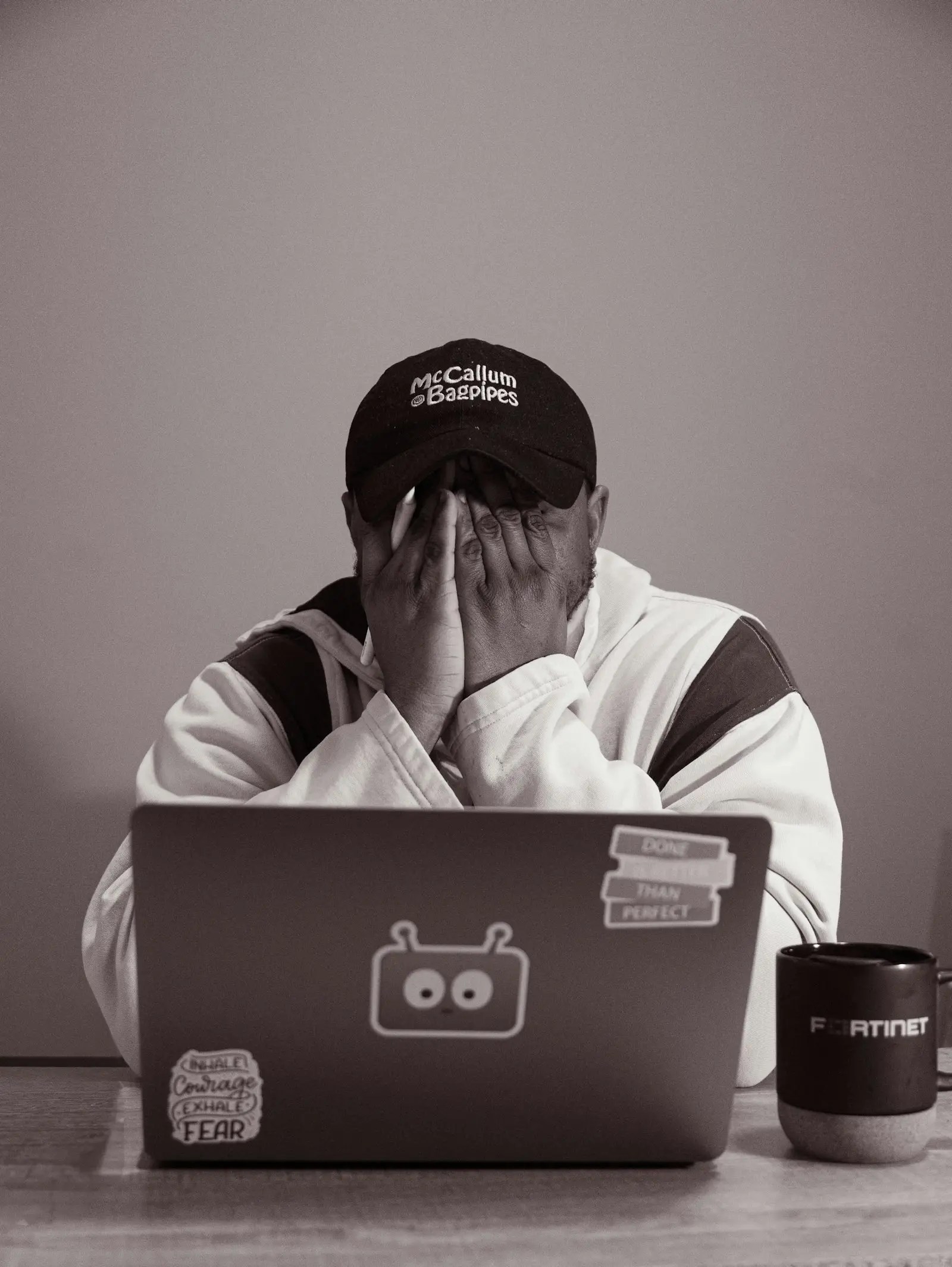 Frustrated person with hands at laptop