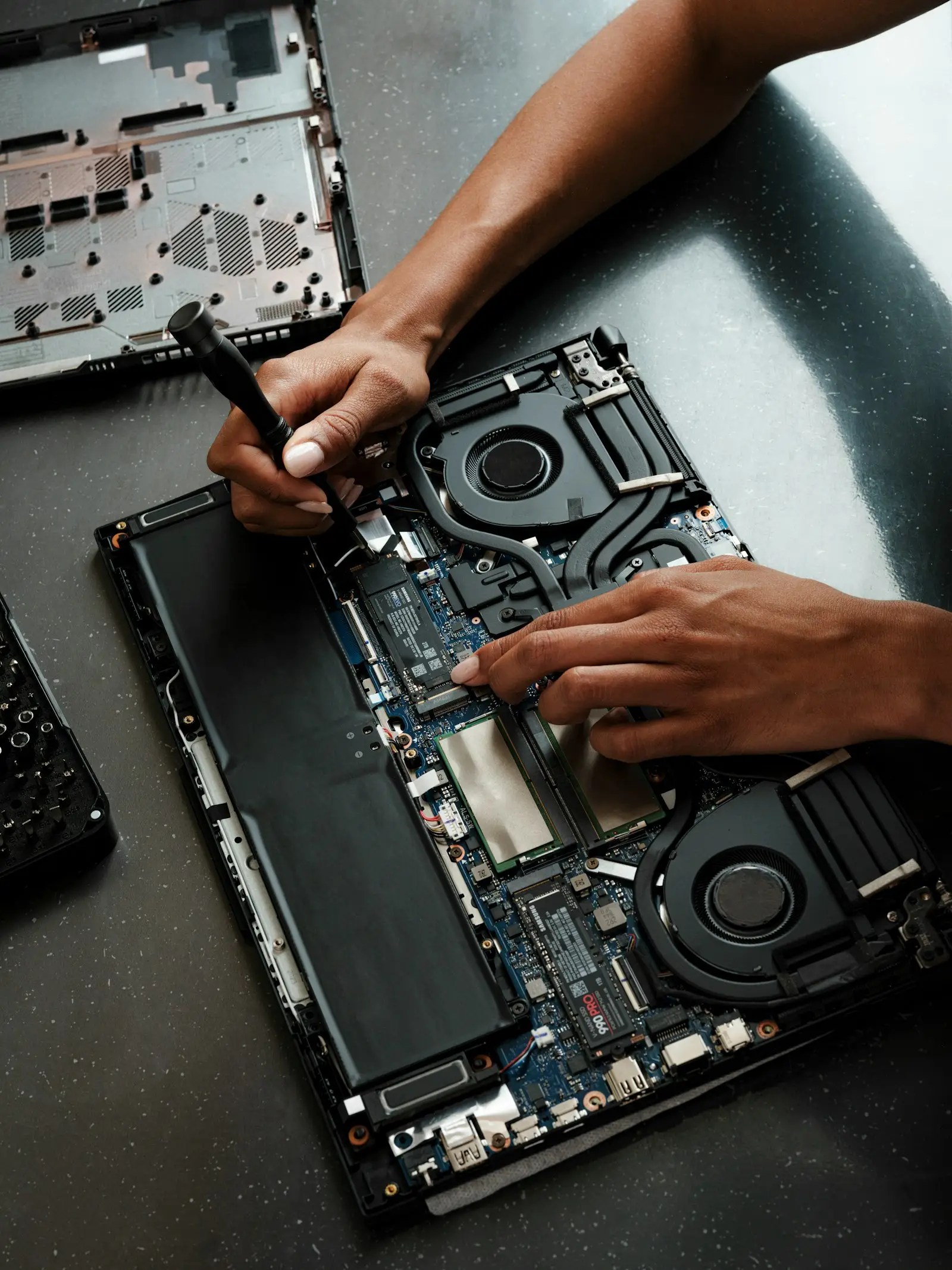 Laptop being repaired with tools