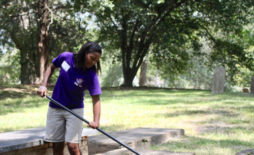 Community members join Demons Days cemetery clean up