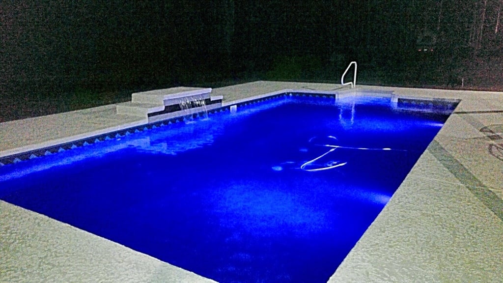 a night time view of a brunswick pool installed