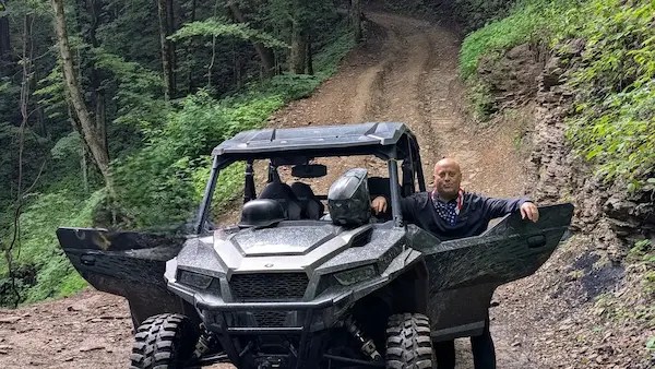 Nathaniel Pool with a UTV on a mountain trail