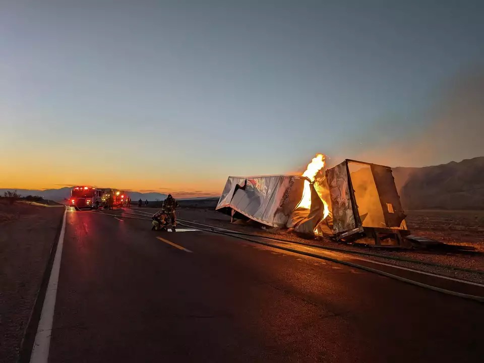 Chick pea-carting semi truck burns on the side of highway in Death Valley.