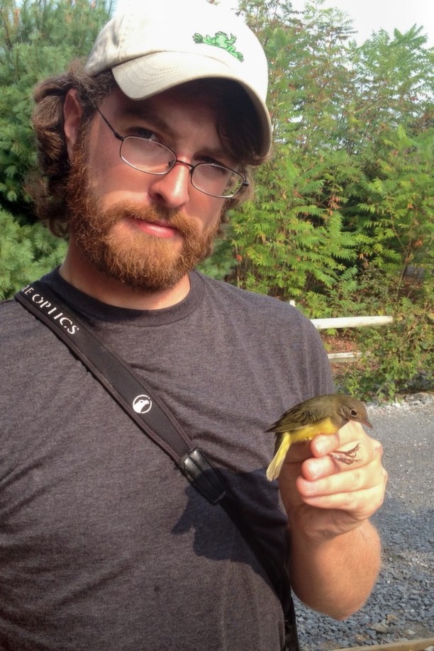 Alex Lamoreaux holding the Connecticut Warbler (Photo by Nate Fronk)