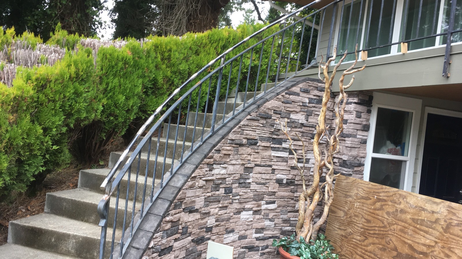 Custom curved steel stair railing fabricated and installed on an outdoor residential staircase in West Vancouver