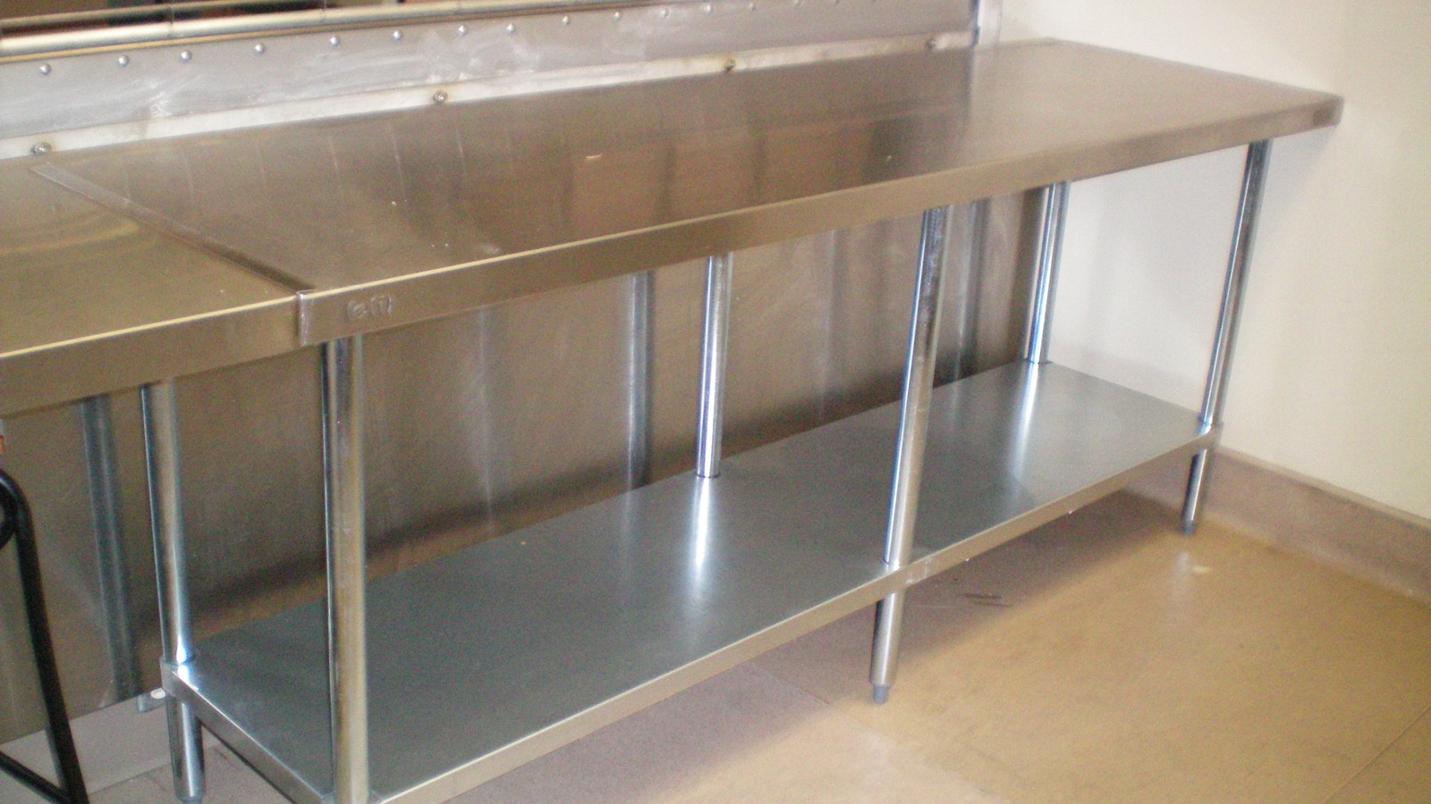 Custom stainless steel work table fabricated and installed for a commercial restaurant kitchen in Vancouver