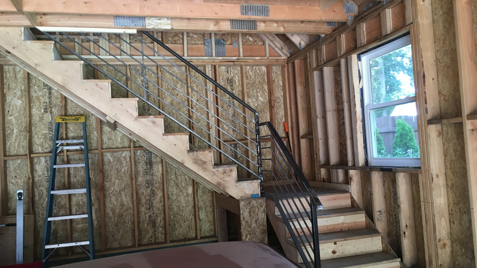 Custom modern steel stair railing with horizontal bars fabricated and installed in a residential home in Langley