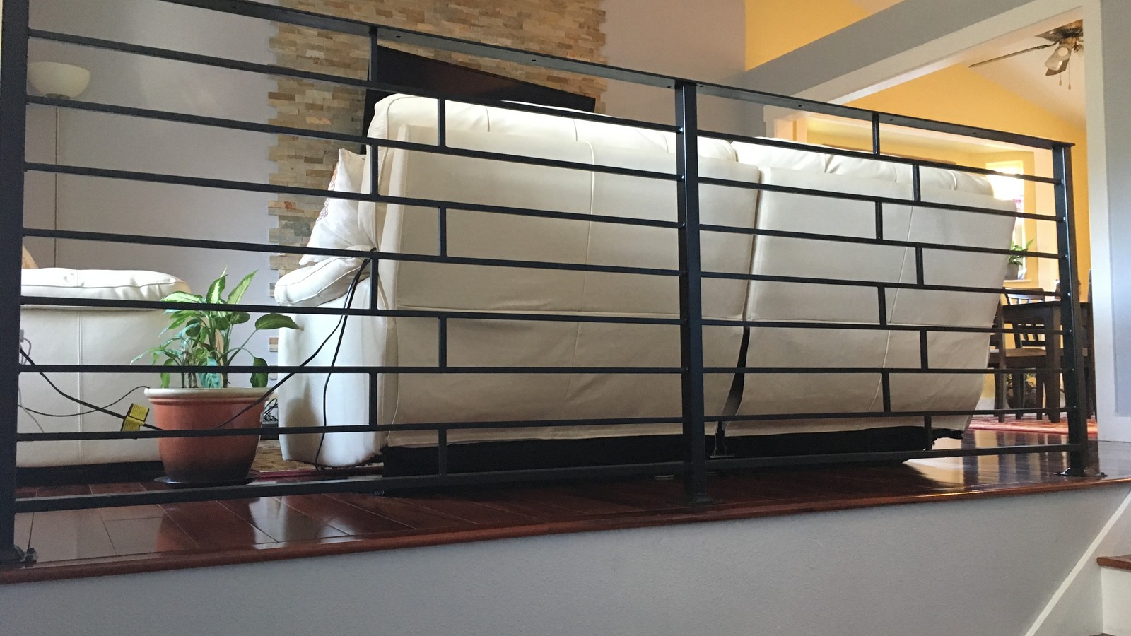Modern black steel interior railing with horizontal bars fabricated and installed in a residential home in Port Coquitlam