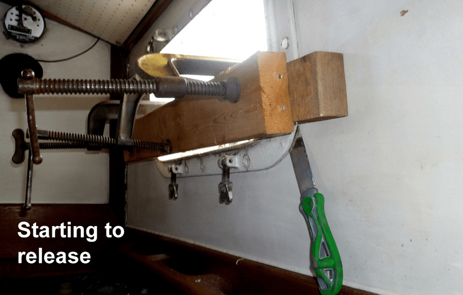 another image of the removal process of an old portlight on a cascade 42.