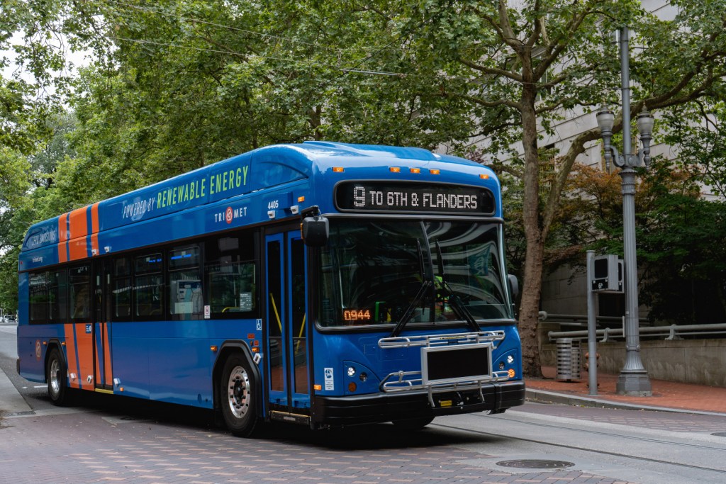 TriMet bus pulling away from a stop.