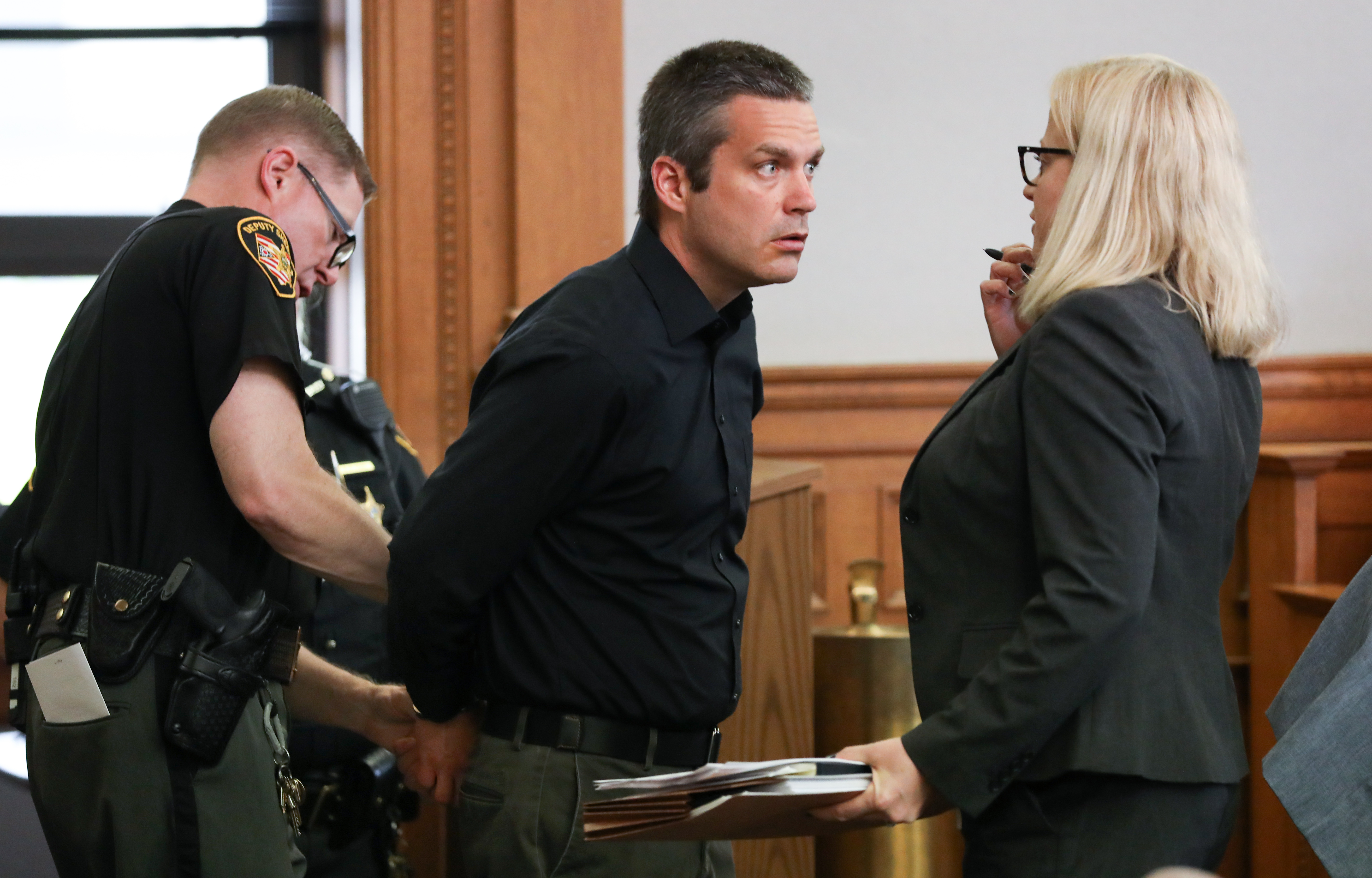 Jason Sybert talks to attorney Jane Roman as he is taken into custody following his arraigned in Lucas County Common Pleas Court Wednesday, May 1, 2019 in Toledo. The Toledo Public Schools substitute teacher is accused of having sex with a Bowsher High School student. THE BLADE/DAVE ZAPOTOSKY
