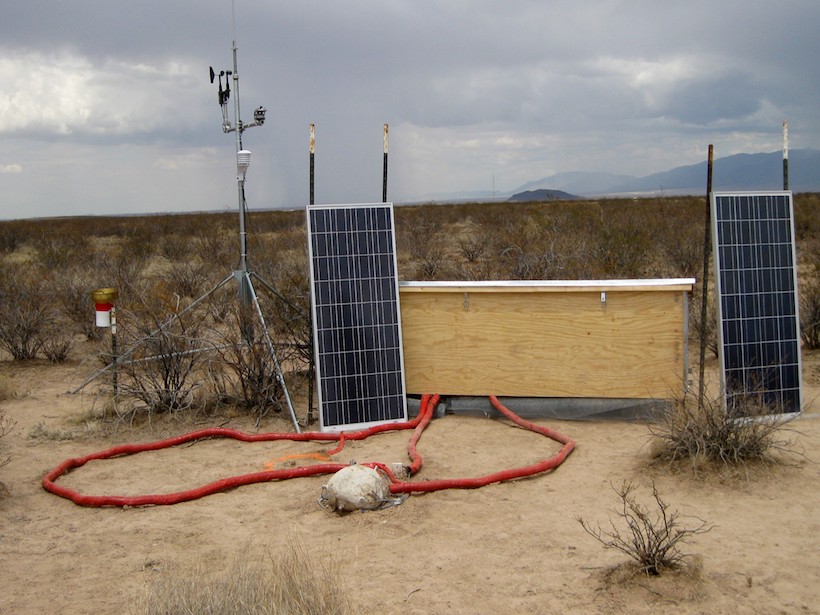 A small boulder in the desert attached to sensors