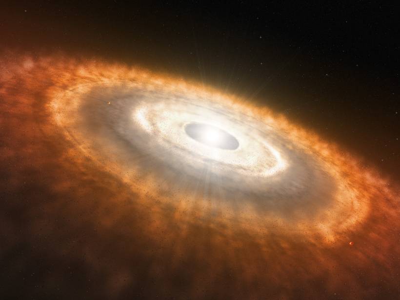 An illustration showing a protoplanetary disk surrounding a young Sun-like star