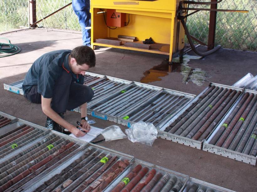 a researcher sampling Precambrian drill core in South Africa
