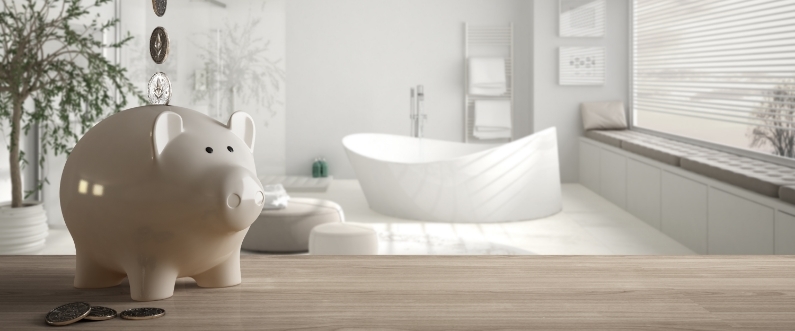a modern, neutral-toned bathroom with a piggy bank and coins on the counter