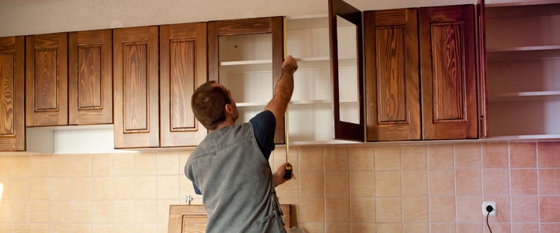 Carpenter working on new kitchen cabinets
