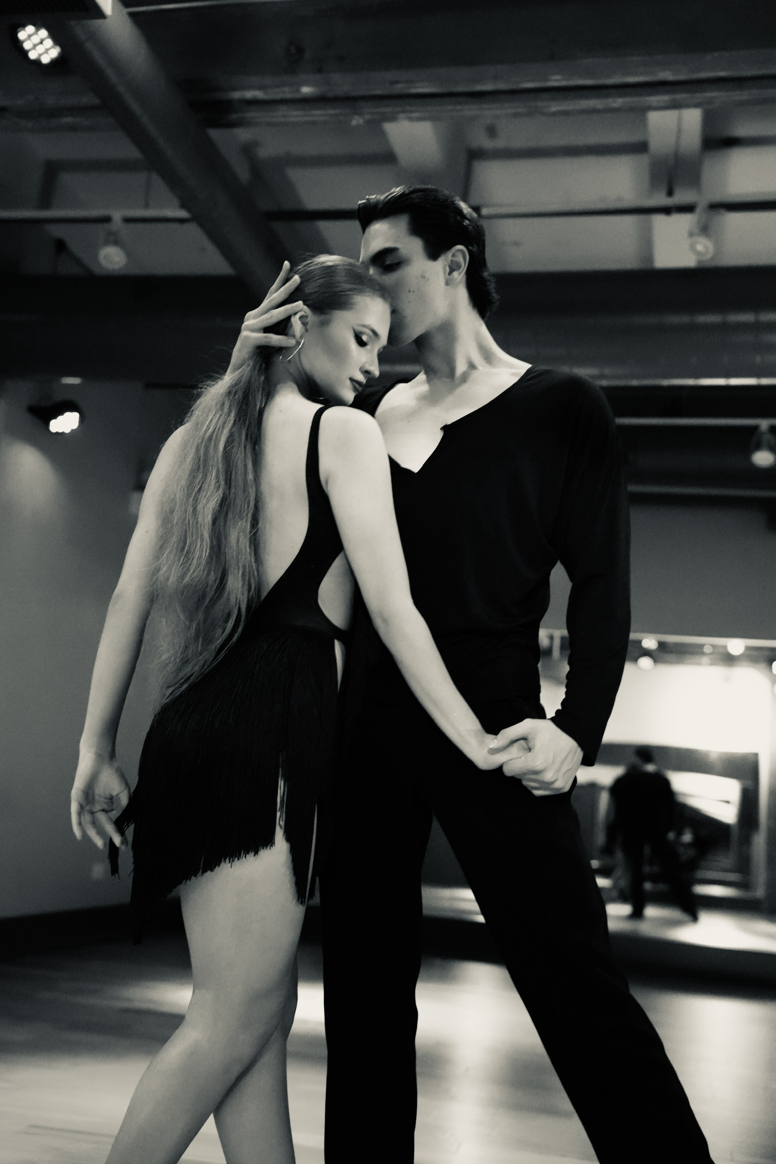 Kye and Anna holding a sculptural International Latin pose