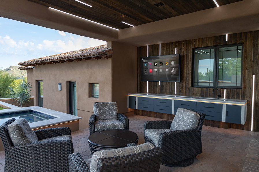outside seating area with an outdoor TV showing a Control4 interface.
