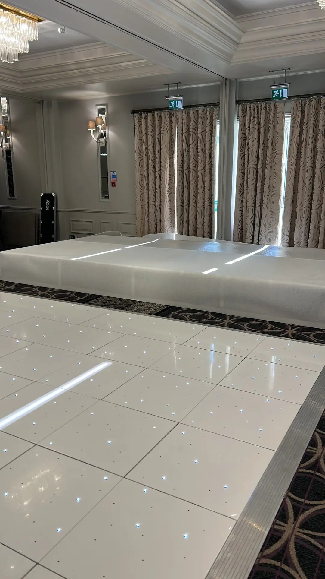 At Nextwave Events & Hire, we specialise in providing exceptional dance floor solutions to elevate your event’s atmosphere, creating an unforgettable experience for all your guests. Whether you’re planning a wedding, corporate event, or any festive occasion, our exquisite range of LED and plain dance floors are perfect for bringing a touch of elegance and vibrancy to your celebration. LED Dance Floor Hire Our LED dance floors are the pinnacle of modern event entertainment. They are designed to captivate and energise your guests, ensuring a lively and memorable party atmosphere. These stunning dance floors come with integrated LED lights that can be programmed to match the theme and color scheme of your event. With their sparkling, starlit effect, they add a magical touch to your venue, making them a popular choice for weddings and gala events. Starlit Dancefloor Hire The starlit dance floor is a crowd favorite, perfect for adding a romantic and enchanting ambiance to your event. These floors are beautifully lit with hundreds of tiny LED lights, resembling a starry night sky. They create a mesmerising effect that not only enhances the beauty of your venue but also encourages your guests to dance the night away under a canopy of twinkling stars. Serving Hertfordshire, Bedfordshire, and London We proudly serve a wide area, including Hertfordshire, Bedfordshire, and London. Our service locations include: St Albans: Known for its historical significance and beautiful architecture, St. Albans provides the perfect backdrop for our elegant dance floors. Hemel Hempstead: In the bustling town of Hemel Hempstead, our dance floors bring an extra layer of excitement and sophistication to any event. Luton: Luton’s vibrant community and diverse event venues are ideal settings for our stunning dance floors. Watford: In Watford, our dance floors complement both intimate gatherings and large-scale events, adding a touch of class and fun. Harpenden, Welwyn Garden City, and Hatfield: These picturesque towns are ideal for weddings and corporate events where our dance floors can shine. Milton Keynes: In the dynamic city of Milton Keynes, our dance floors are a popular choice for a variety of events, from corporate functions to celebratory parties. Variety of Sizes and Styles We understand that every venue and event theme is unique. That’s why we offer our dance floors in a variety of sizes and styles to suit your specific needs. Whether you’re hosting a grand ballroom gala or an intimate garden wedding, we have the perfect dance floor to fit your space and enhance your event’s overall aesthetic. Hassle-Free Installation and Removal Our team at Nextwave Events & Hire is dedicated to making your event planning process smoother and more enjoyable. We provide hassle-free installation and removal services for all our dance floors. Our professional and friendly staff ensure that the dance floor is set up safely and efficiently, ready for your guests to enjoy. After the event, we take care of the removal process, ensuring that everything is done seamlessly and with minimal disruption to you and your venue. Perfect for All Occasions Whether it’s a wedding, a corporate event, a birthday party, or any other celebration, our dance floors are designed to cater to a wide range of occasions, adding a touch of elegance and excitement to your event. The versatility of our floors means they can seamlessly integrate with various themes and settings, ensuring that they complement the tone and style of your event perfectly. Customisation to Match Your Theme We understand the importance of having every detail of your event tailored to your vision. That’s why we offer customisable options for our dance floors. From the pattern of the lights to the color schemes, we can adjust our floors to align with your event’s theme, ensuring a cohesive and stunning visual experience. Safe and Reliable Safety is paramount in our services. Our dance floors are constructed with high-quality materials and adhere to strict safety standards. They are sturdy, slip-resistant, and designed to withstand the excitement of a busy event. You can have peace of mind knowing your guests can dance safely and comfortably. Enhancing Your Event’s Atmosphere A dance floor is more than just a place for dancing; it’s a central feature that can set the tone for your entire event. Our LED and plain dance floors are designed not only for functionality but also to create an inviting and dynamic atmosphere. They encourage guests to interact, dance, and enjoy the event to its fullest, making your celebration a truly memorable one. Professional Consultation and Support At Nextwave Events & Hire, we offer professional consultation to help you choose the best dance floor for your event. Our experienced team will discuss your needs, preferences, and the specifics of your venue to recommend the most suitable options. We are committed to providing exceptional customer service and support throughout the entire process, from initial inquiry to post-event follow-up. Competitive Pricing and Packages We offer competitive pricing and packages tailored to meet a range of budgets and requirements. Whether you’re planning a lavish affair or a modest gathering, we have options that will provide excellent value without compromising on quality or style. Building Lasting Memories Our ultimate goal is to help you create lasting memories. A dance floor is where many special moments happen, from the first dance at a wedding to the joyous celebration at a milestone birthday party. With Nextwave Events & Hire, you can trust that these moments will be cherished and remembered for years to come. Contact Us for Your Next Event Ready to add a spectacular dance floor to your next event in Hertfordshire, Bedfordshire, or London? Contact Nextwave Events & Hire today. Let us help you make your event not just an occasion but an experience that stands out and remains etched in the hearts and minds of all your guests.