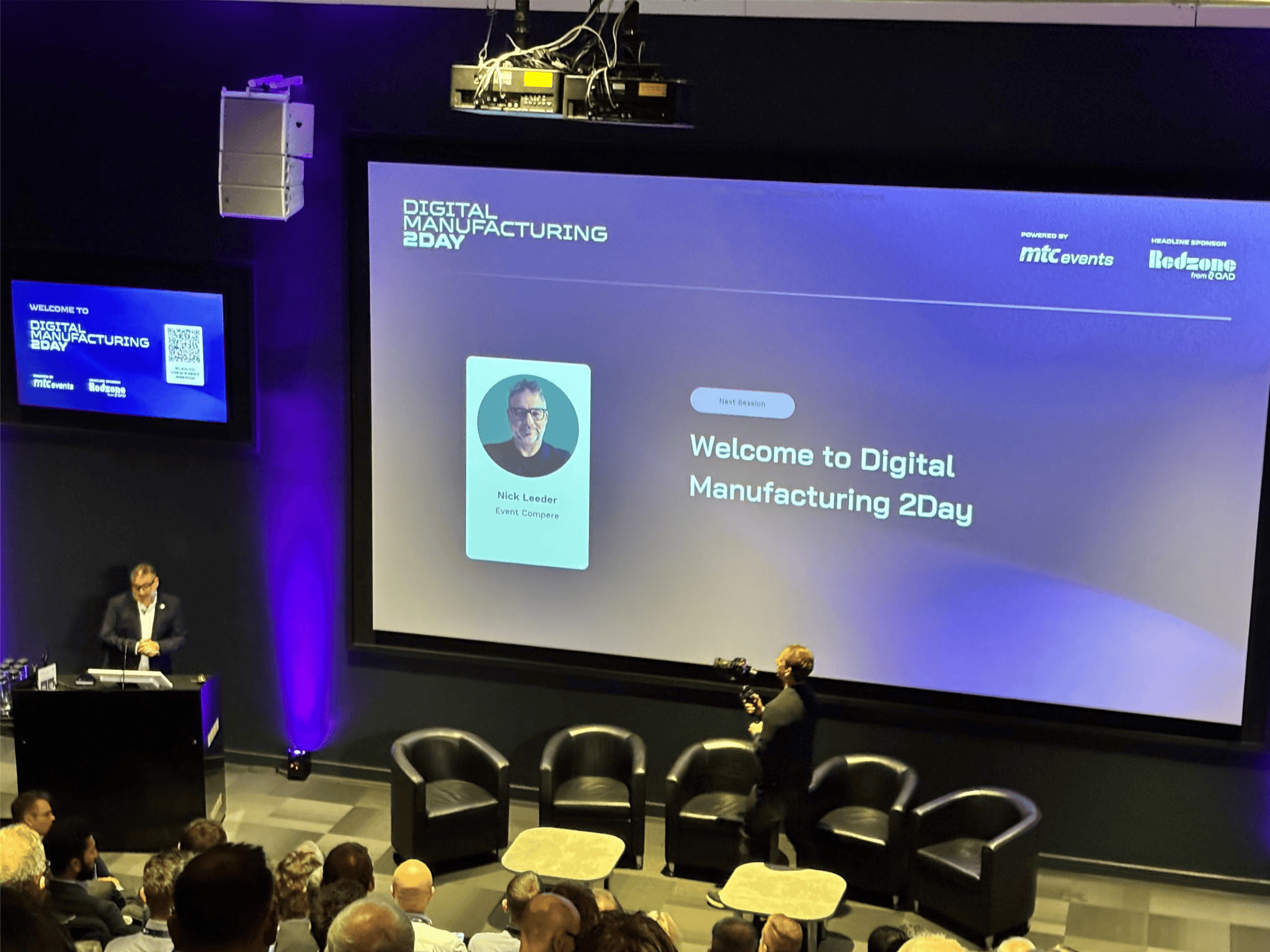 Nick Leeder at the lectern opening Digital Manufacturing 2Day 2026 at the MTC, screen reading Nick Leeder, Event Compere, Welcome to Digital Manufacturing 2Day