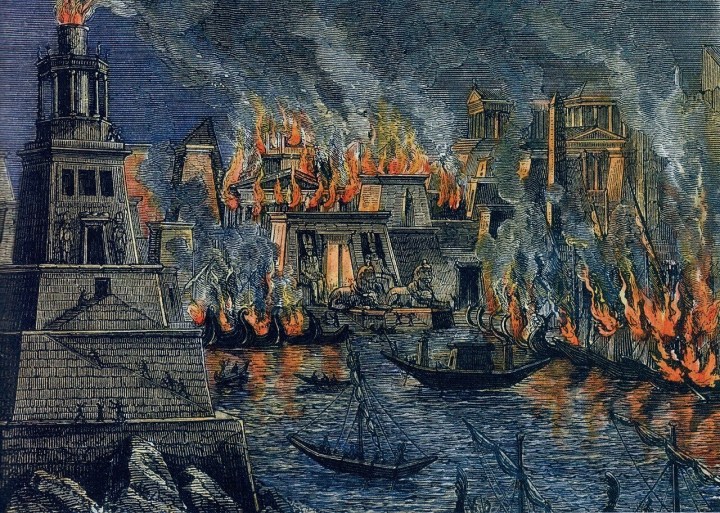 A nineteenth-century woodcut depicting flames engulfing a large classical building as figures flee in the foreground.