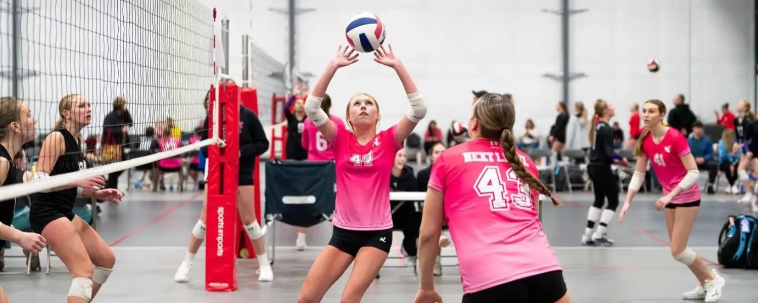girls competing in volleyball tournament