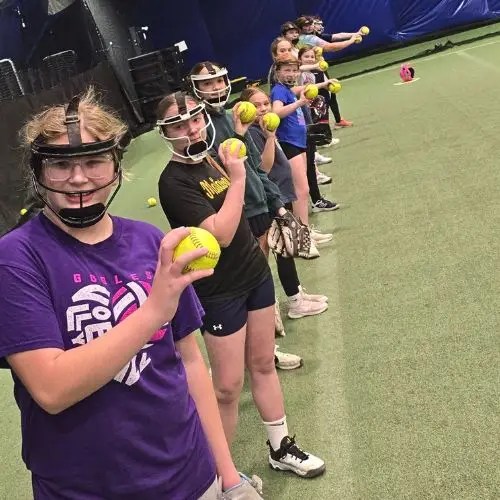 line of girls holding a softball