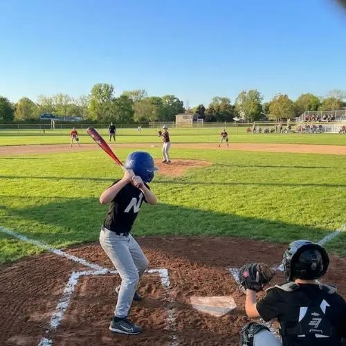 boy at bat on baseball field