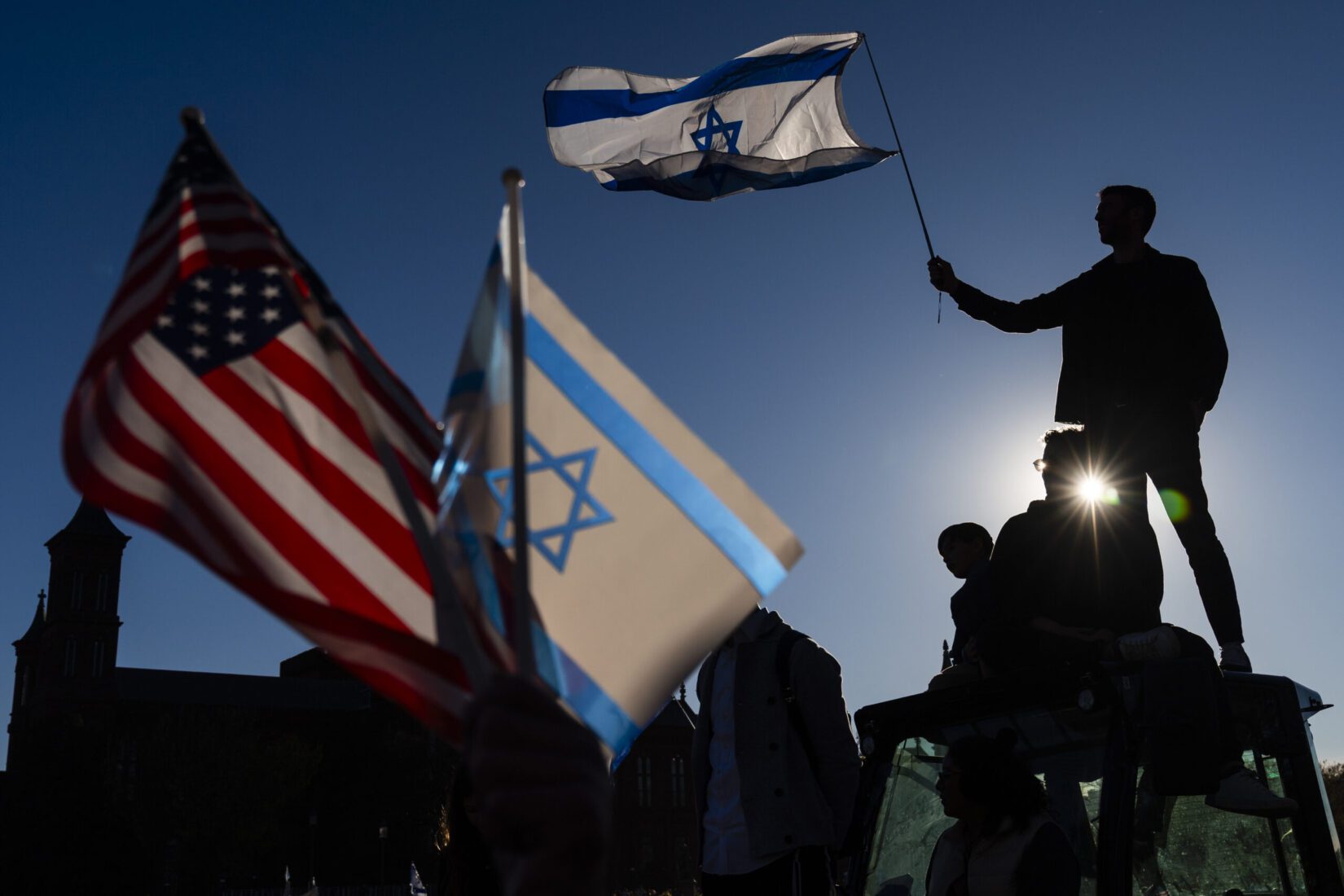 A man waves an Israeli flag during a pro-Israel demonstration on the National Mall in November 2023, about a month after Hamas militants attacked Israel from the Gaza Strip.