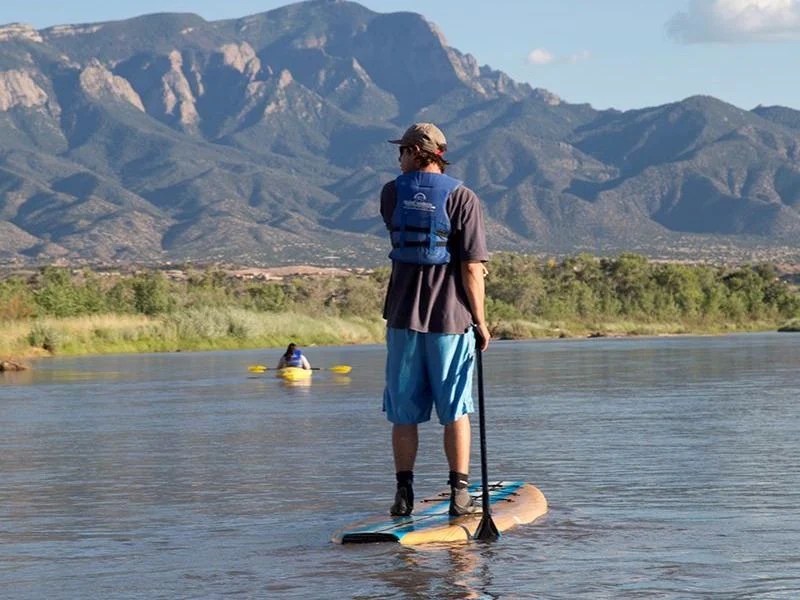 A paddleboarder moves down the Rio Grande.