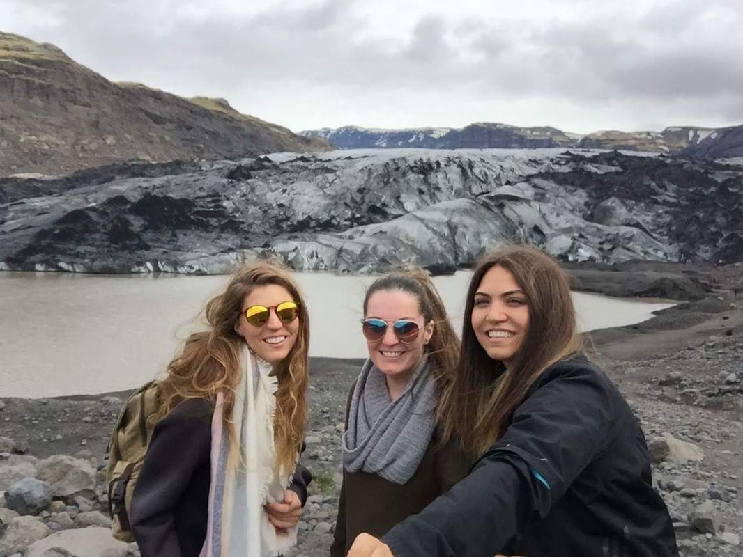 Three girls in front of a melting glacier in Iceland
