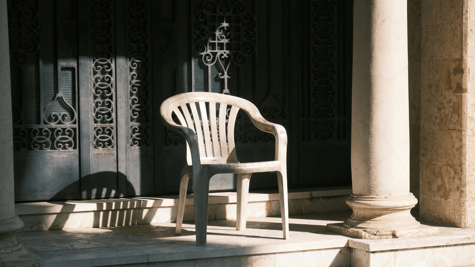 An empty chair on a front porch, symbolizing the grief of leaving alcohol behind.