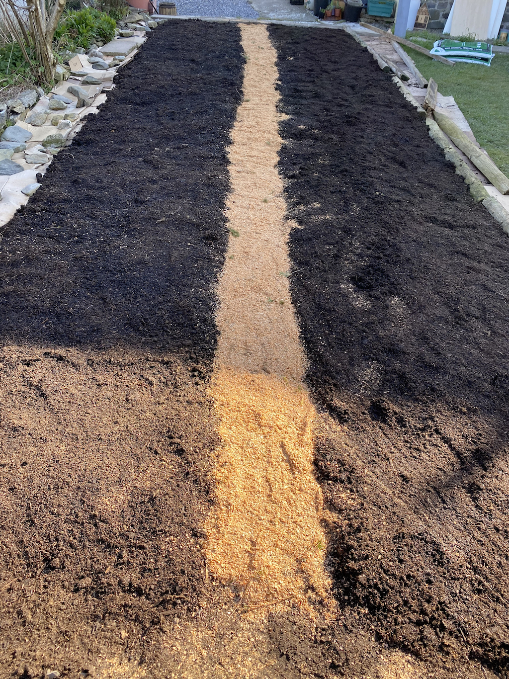 sawdust mulch on card for paths