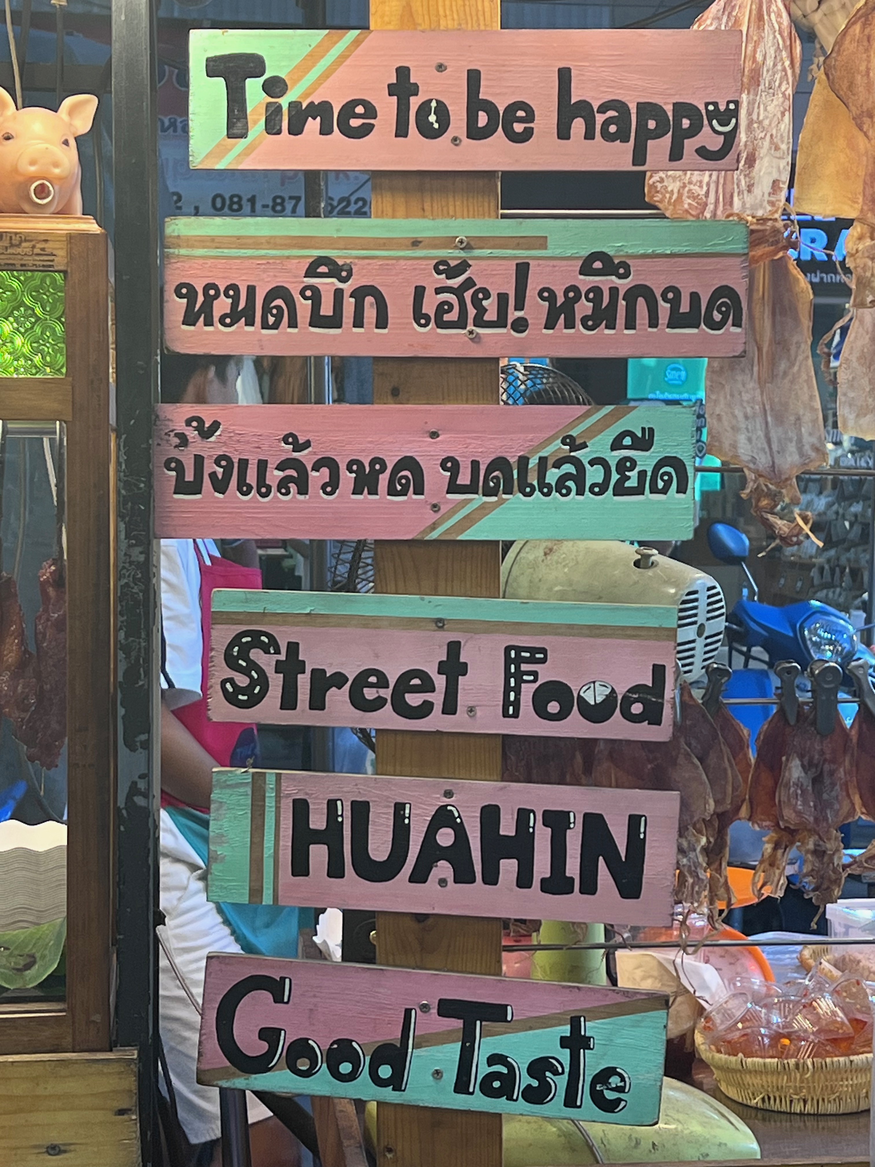 street food sign made from wood, written in Thai and the English "Street Food Hua Hin"