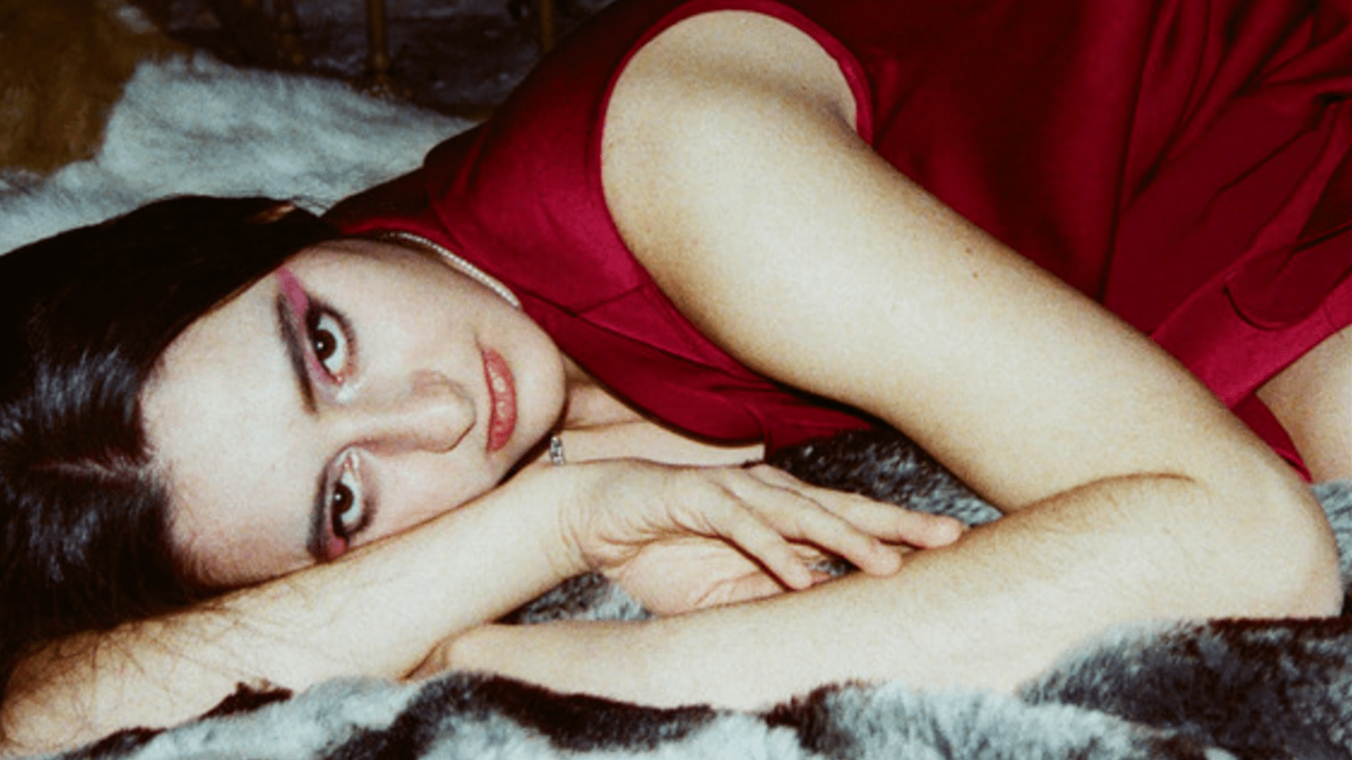 'Soulmates Slay' promotional picture of Sofia Bianchi aka Softey in a red dress as she lays on a blanket.
