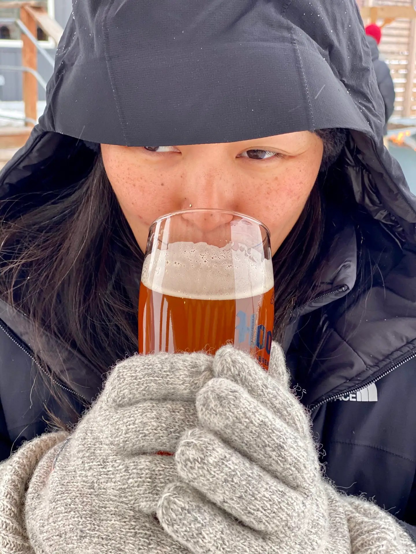 Tiff drinking a very frosty beer and wondering why she let me talk her into the cold...