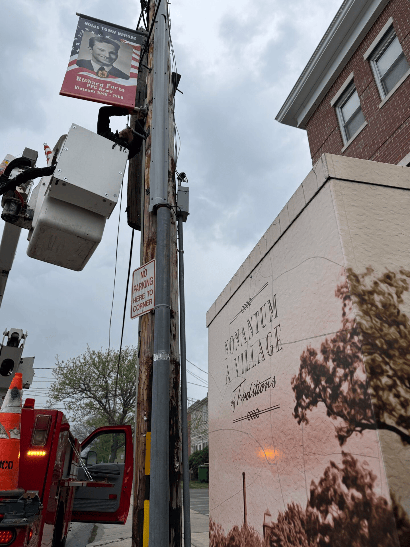 bucket truck installing pole banner