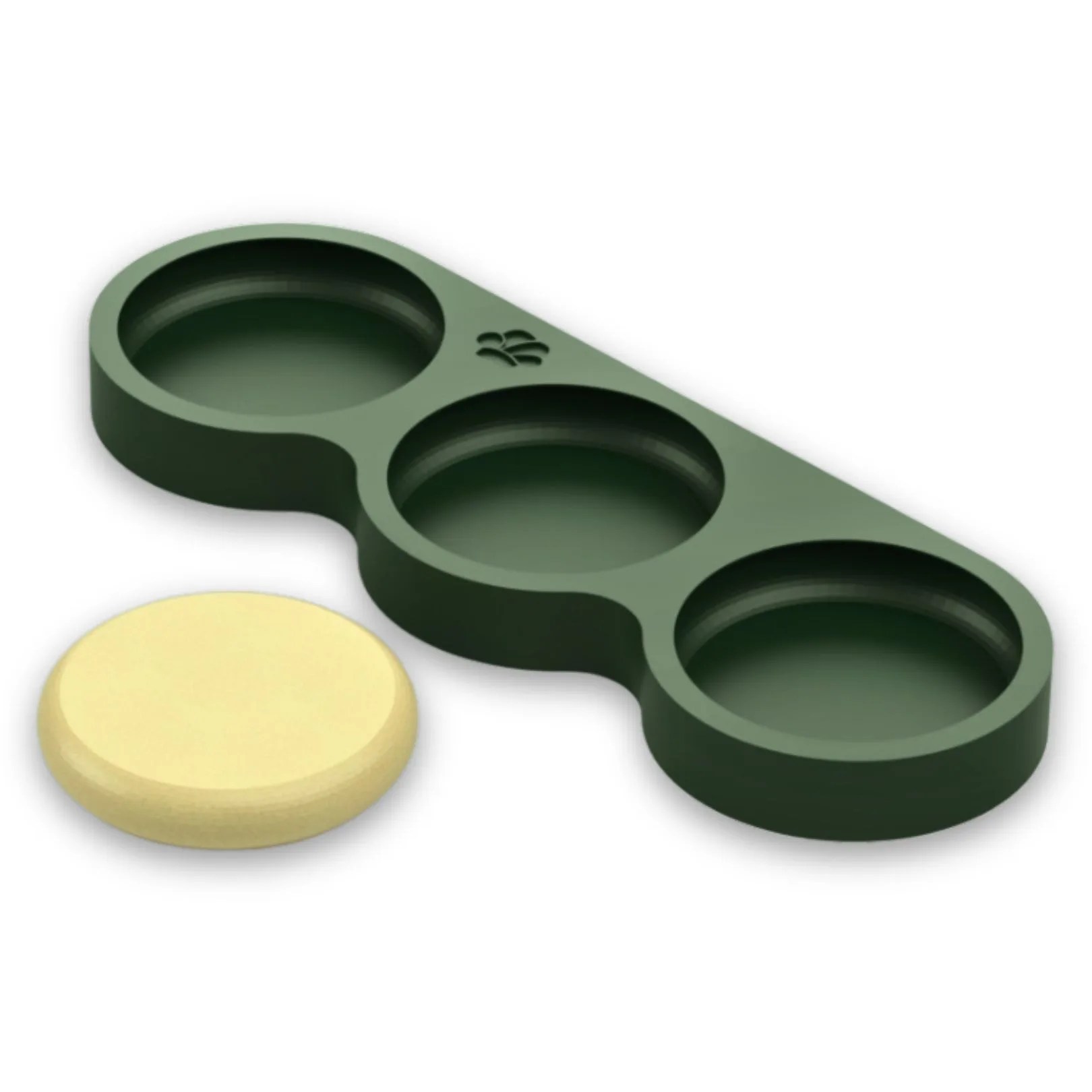 Round molds with one yellow disk, green holder.