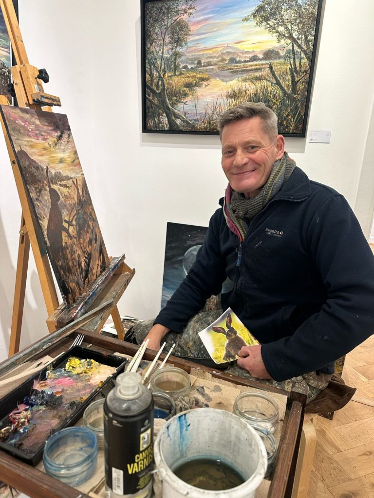 Jon Minshull painting Beltane Rabbits, photo by Gregory Taylor