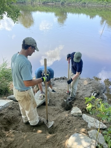 A Northern Forest Canoe Trail crew works along the Missisquoi River in Vermont.