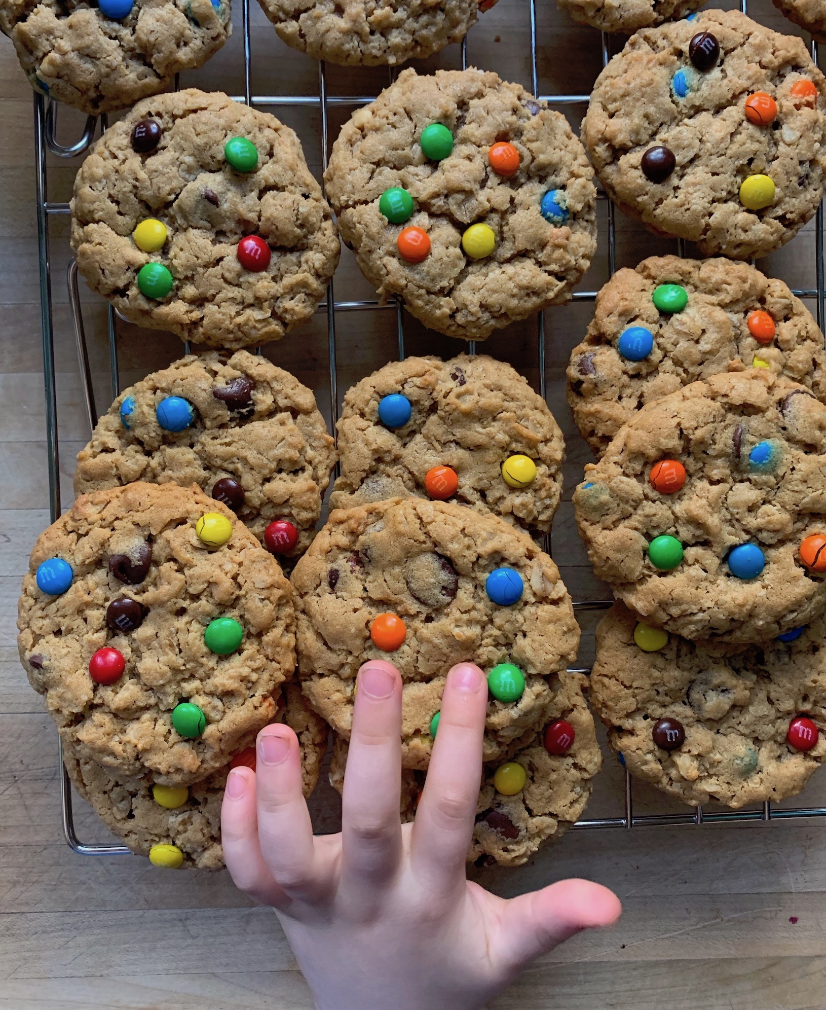 child precociously touching a cooling cookie