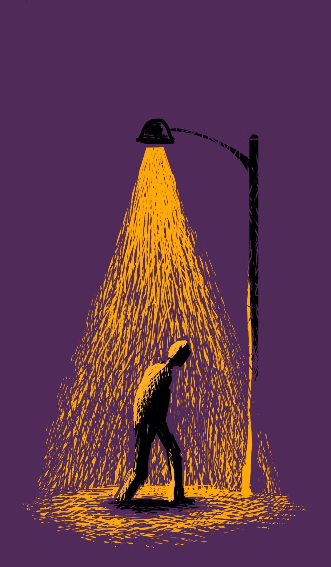 A person walks under a streetlamp at night