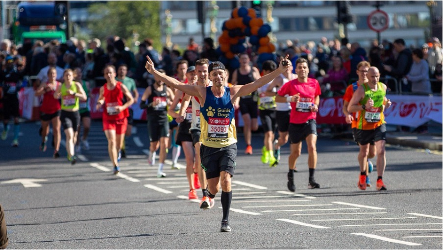 Runner’s feet in supportive running shoes, mid-stride on a road.