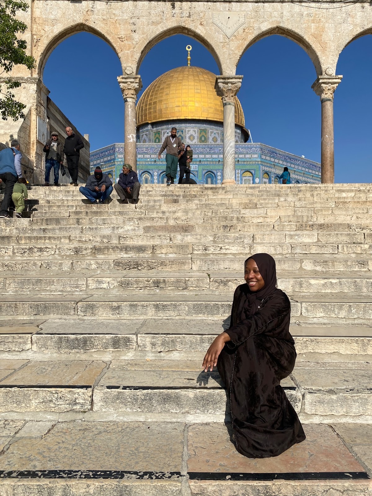 Nsenga Knight sitting on the steps leading up the the Al Aqsa Mosque in Jerusalem, Palestine