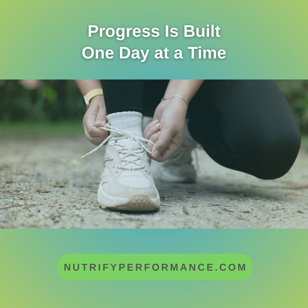 A woman crouches outdoors tying her running shoe, representing progress built through small, daily actions.