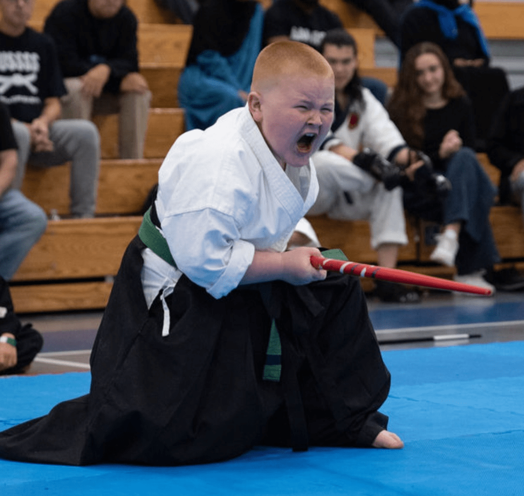 boy in fight pose with staff in hand