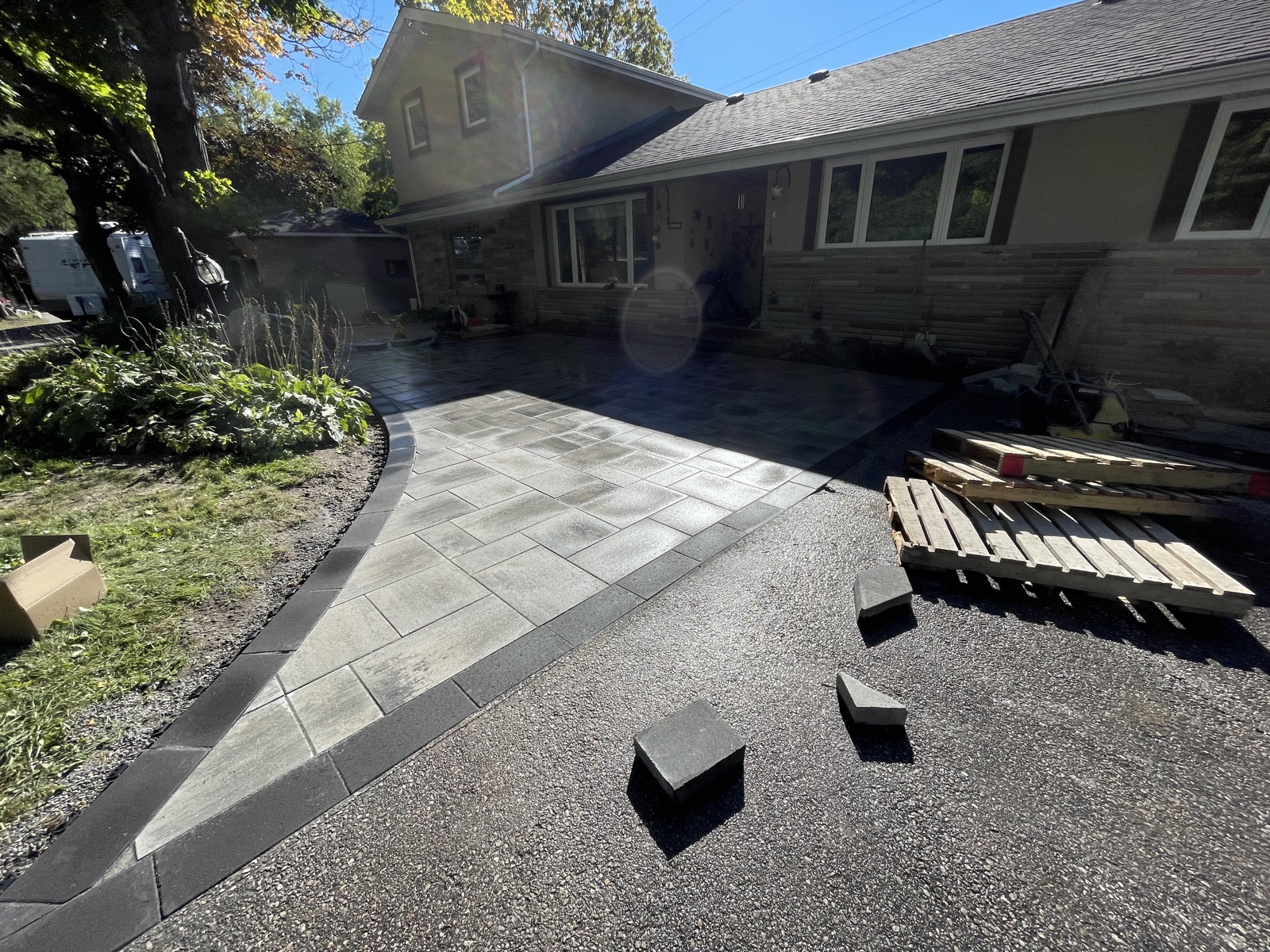 Finished interlocking driveway viewed beside garage — OCM Interlocking, GTA