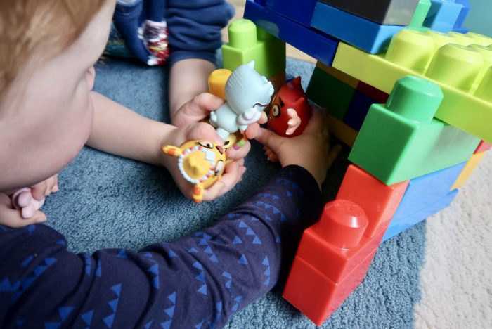 Children playing with plastic figures from the Love Monster TV show