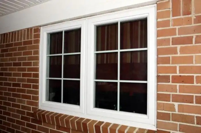Vinyl frame window on a bricked wall