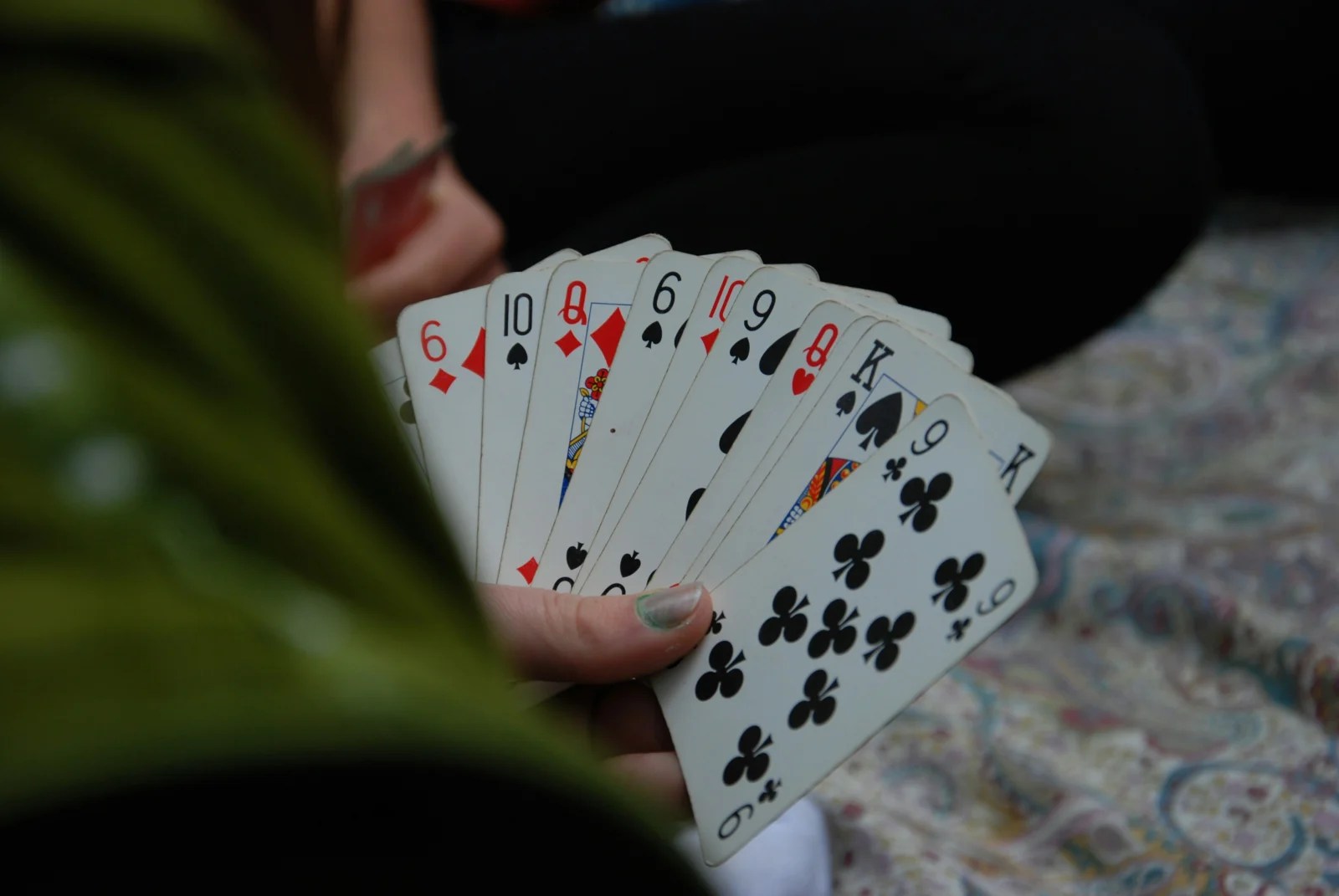 A hand holding playing cards