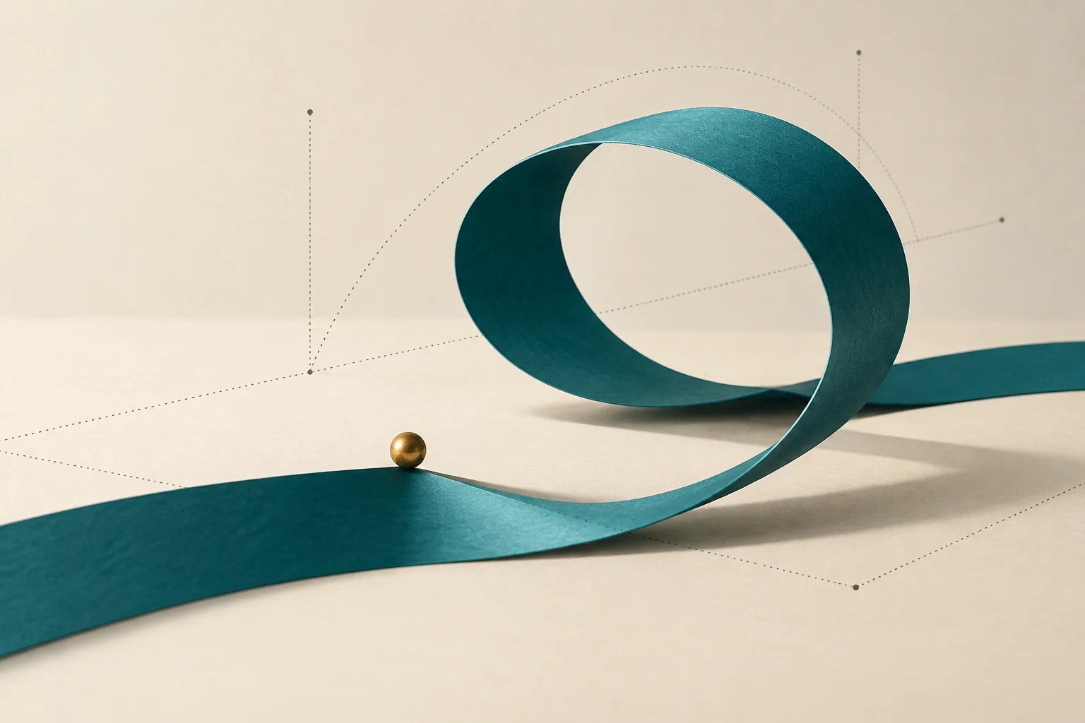 A folded cream paper loop beside a gold sphere.